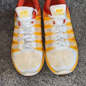 White yellow and orange nike running shoes size 8.5
